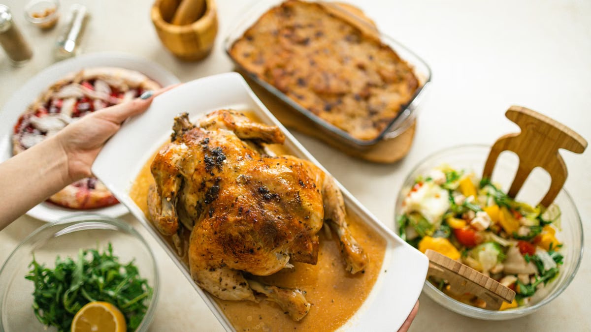 Savory roasted chicken served with fresh salad and baked side dishes.